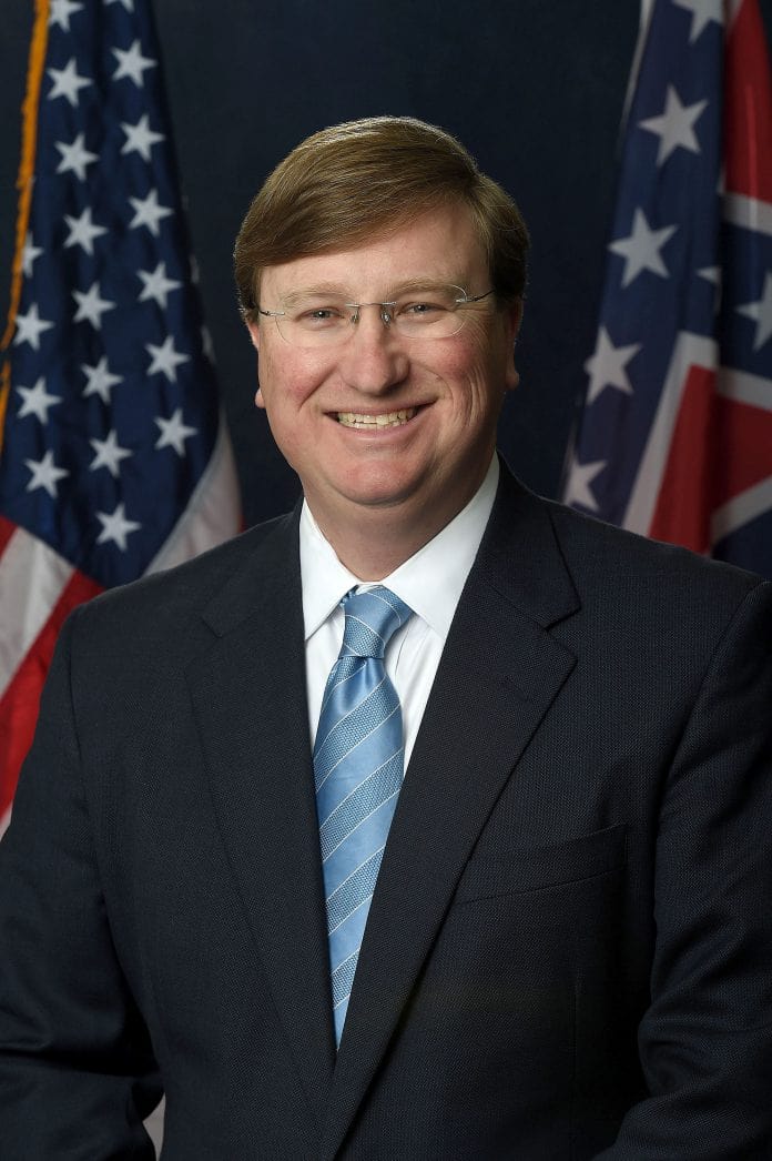 portrait of Mississippi governor Tate Reeves with US flag in background